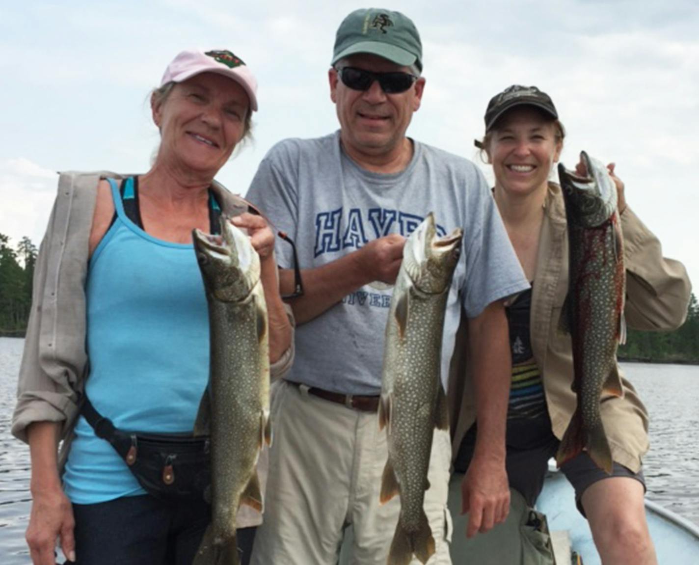 TROUT TRIFECTA Greg and Lynette Hayes of Delano, along with Cheryl Nelson of Rockford, managed to boat these three lake trout simultaneously in a flury of action on Lake Saganaga in June without tangling one-another. Not pictured, net and bait boy Mark Nelson, also of Rockford.