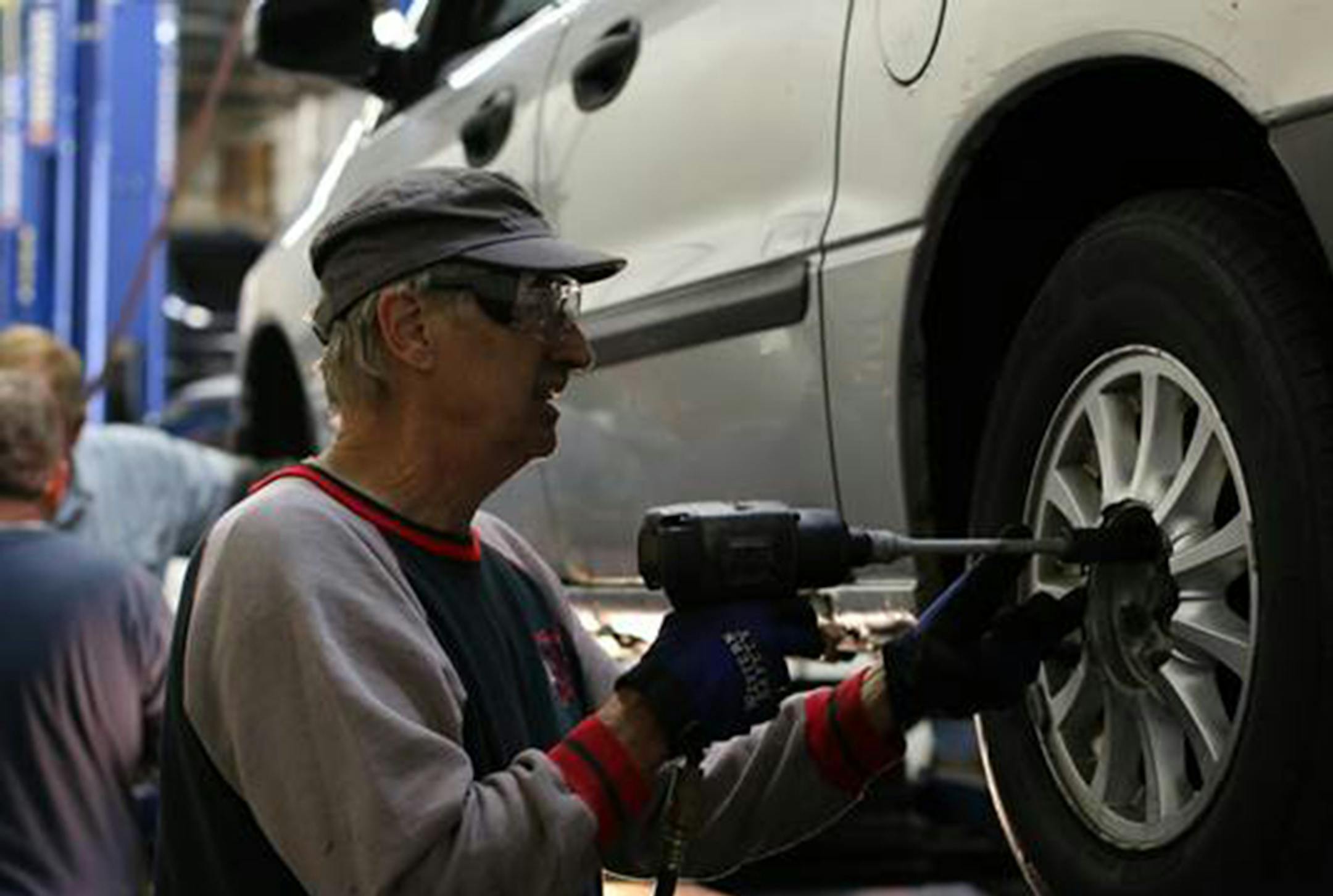 Cars for Neighbors Board member, Richard Krusemark, works on a vehicle to be given to a family in need during Car Care Saturday (Oct. 4).
