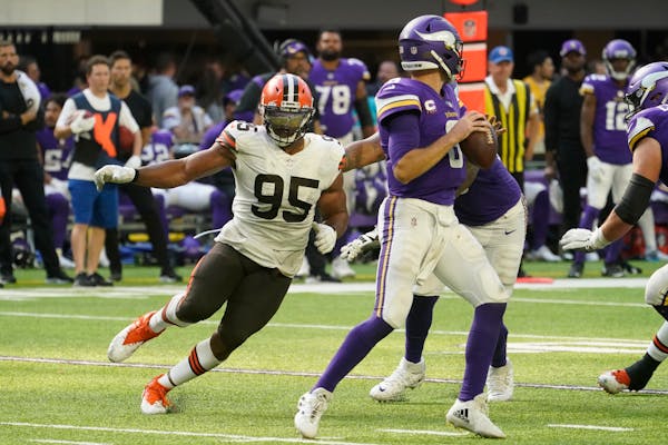 Cleveland Browns defensive end Myles Garrett (95) pressures Minnesota Vikings quarterback Kirk Cousins (8) during the second half of an NFL football g