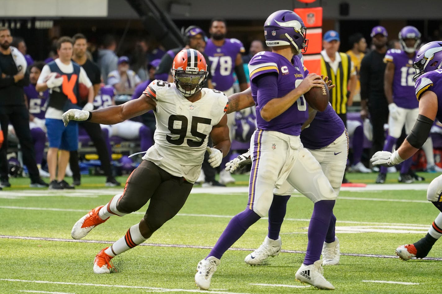 Cleveland Browns defensive end Myles Garrett (95) pressures Minnesota Vikings quarterback Kirk Cousins (8) during the second half of an NFL football game, Sunday, Oct. 3, 2021, in Minneapolis. The Browns won 14-7. (AP Photo/Jim Mone)