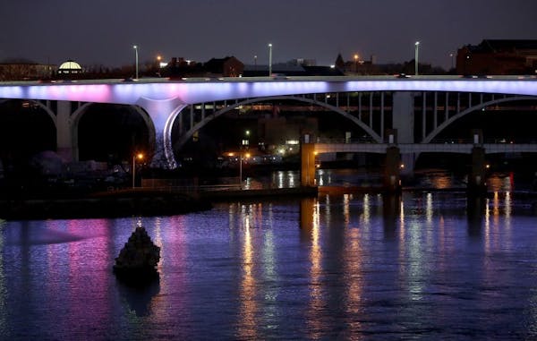 The I-35W bridge lit up in French national colors in support of Paris and the people of France.