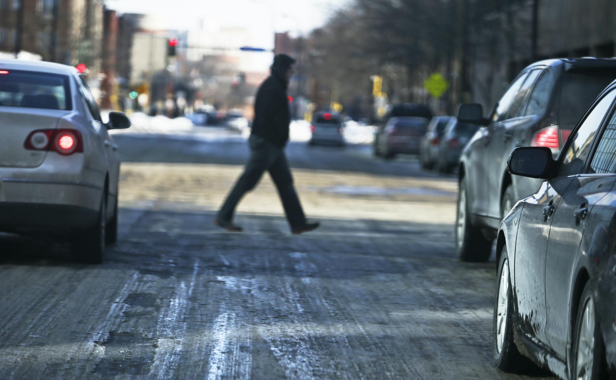Motorists and pedestrians alike must tread carefully while navigating thick, ice covered streets along 8th St. S.