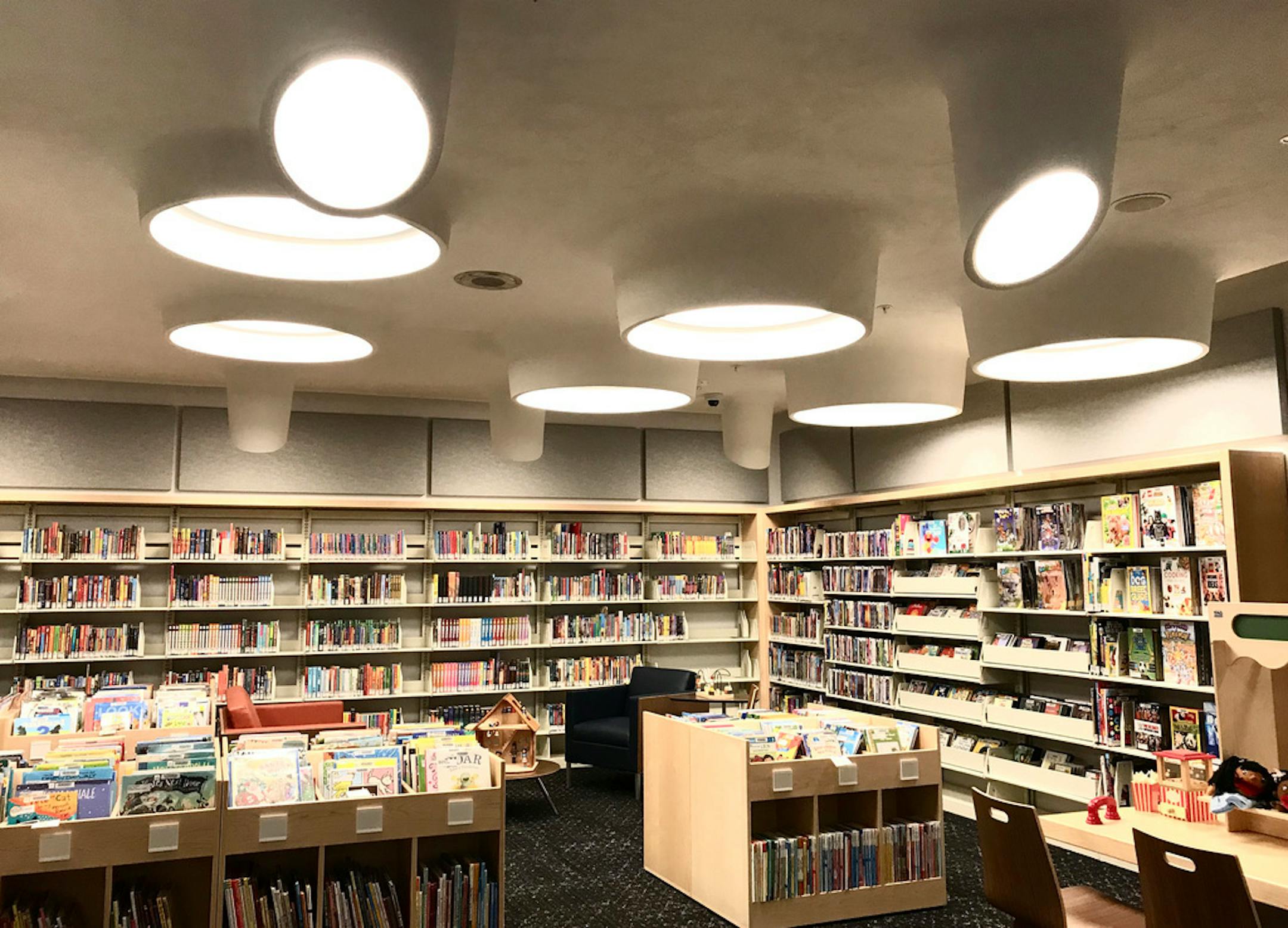 The children's room of the Arvonne Fraser Library. To contrast with Rapson's original dark-stained oak doors, MacDonald & Mack designed bookshelves using light maple. They're 16 inches lower than their predecessors, which were blocking sightlines.