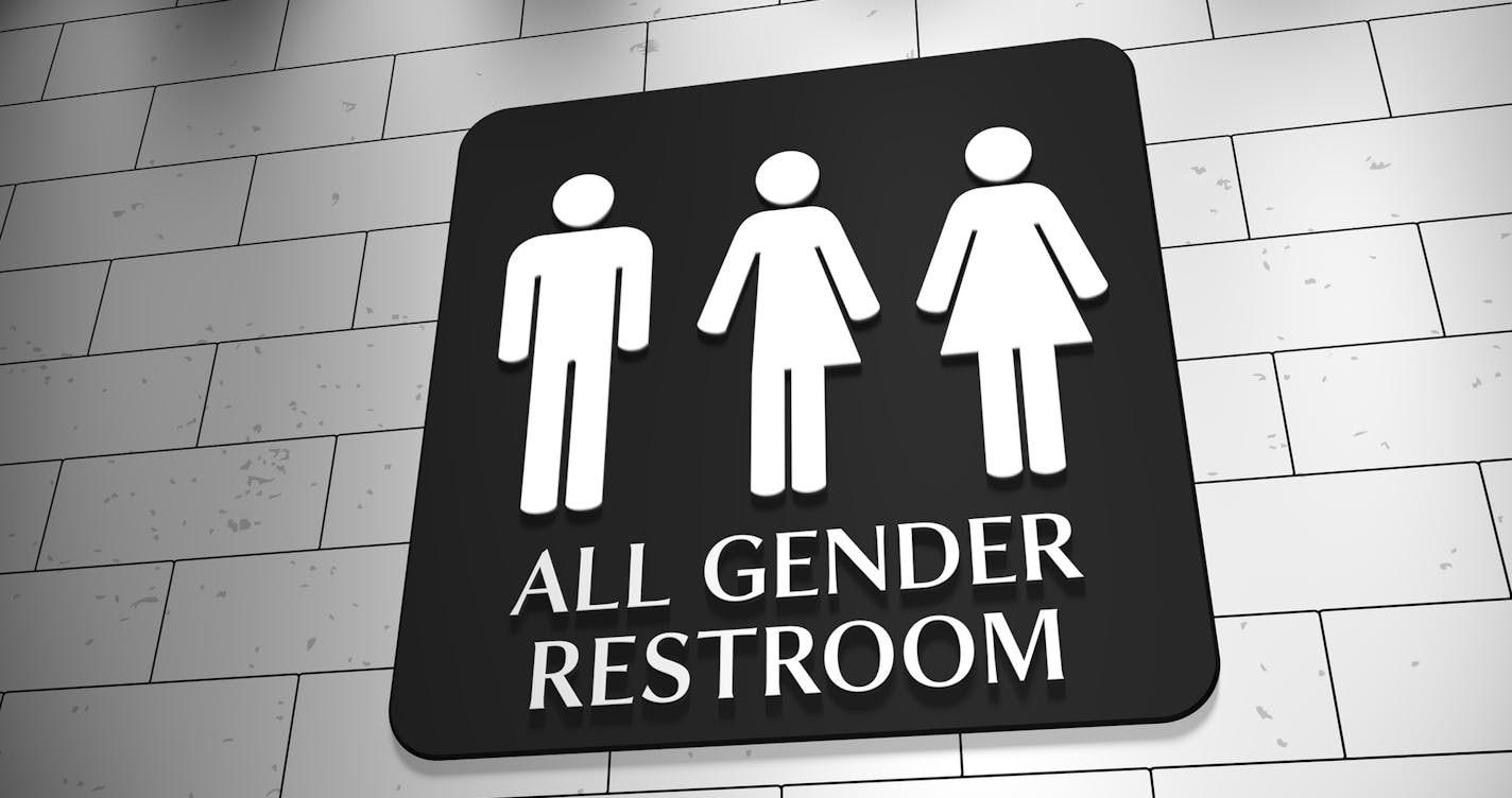 iStock
A sign on a wall for "All Gender Restroom" with symbols for men, trans and women. LGBT issue.