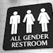 iStock
A sign on a wall for "All Gender Restroom" with symbols for men, trans and women. LGBT issue.