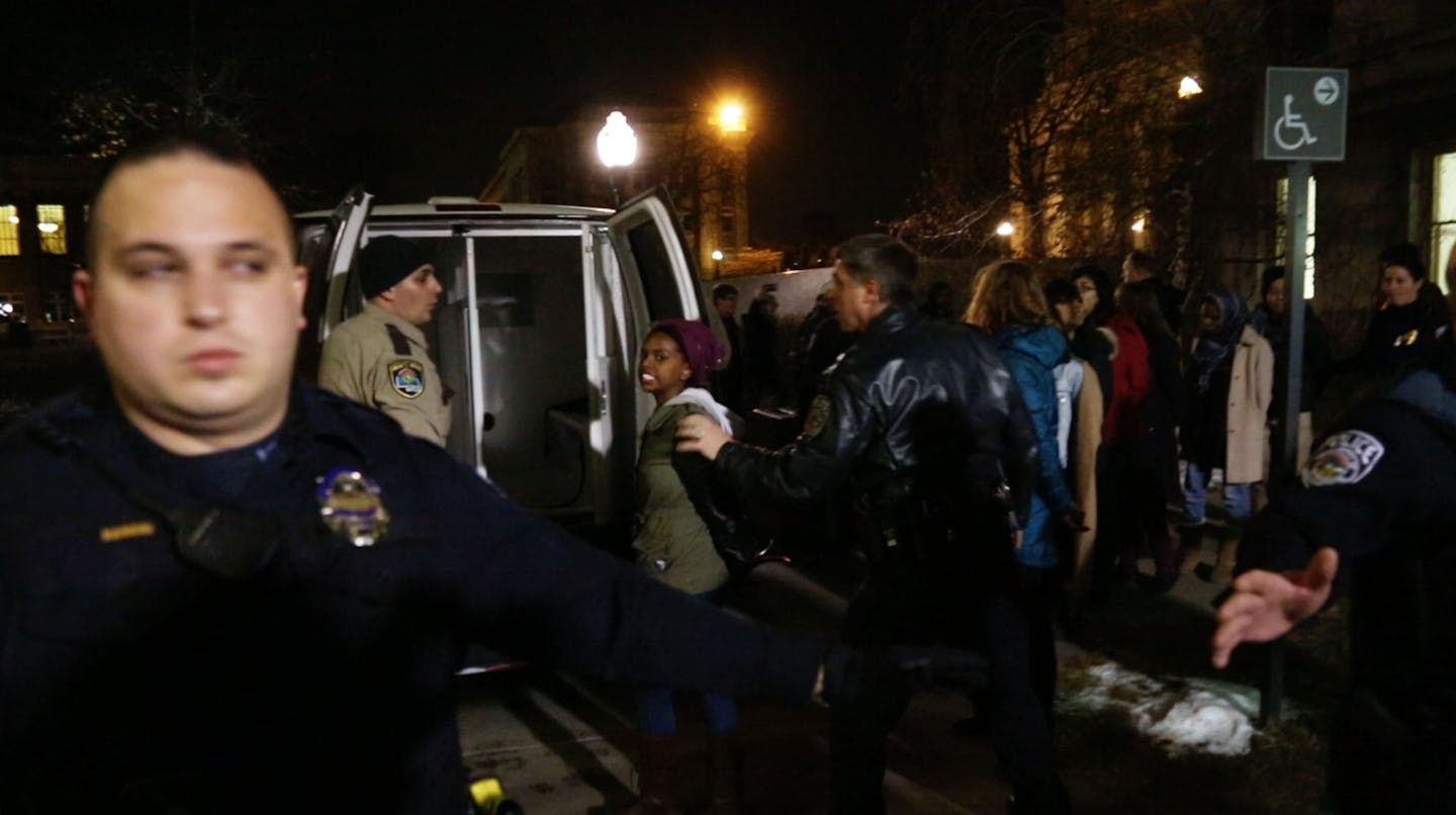 University of Minnesota police and Hennepin County Sheriff's deputies loaded protesters into the back of a Sheriff's van outside of Morrill Hall.