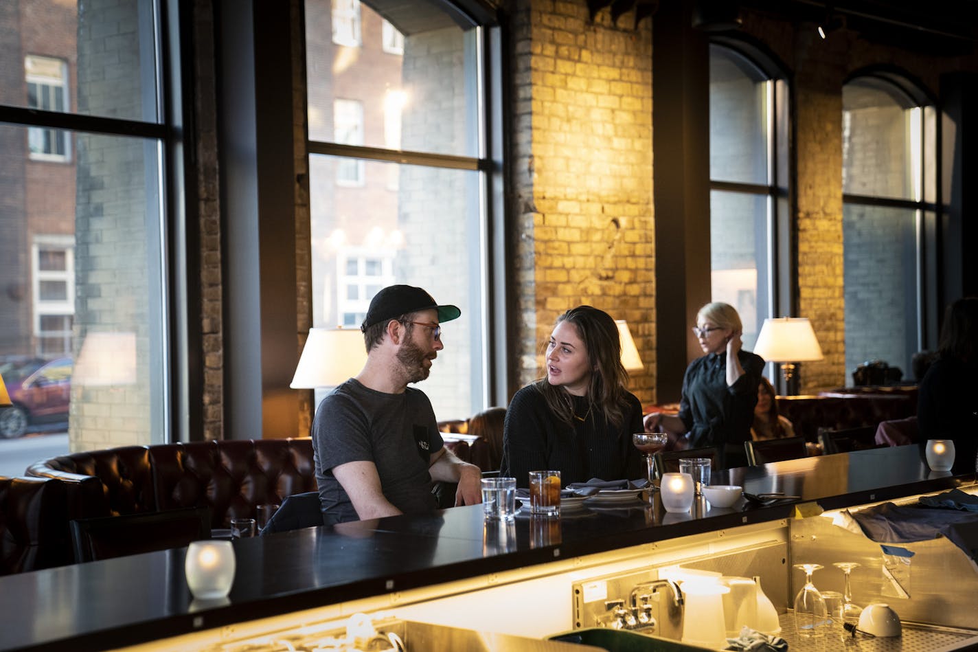 Spouses Austin and Merritt Bamrick enjoy drinks and dinner at the bar at Snack Bar in Minneapolis.