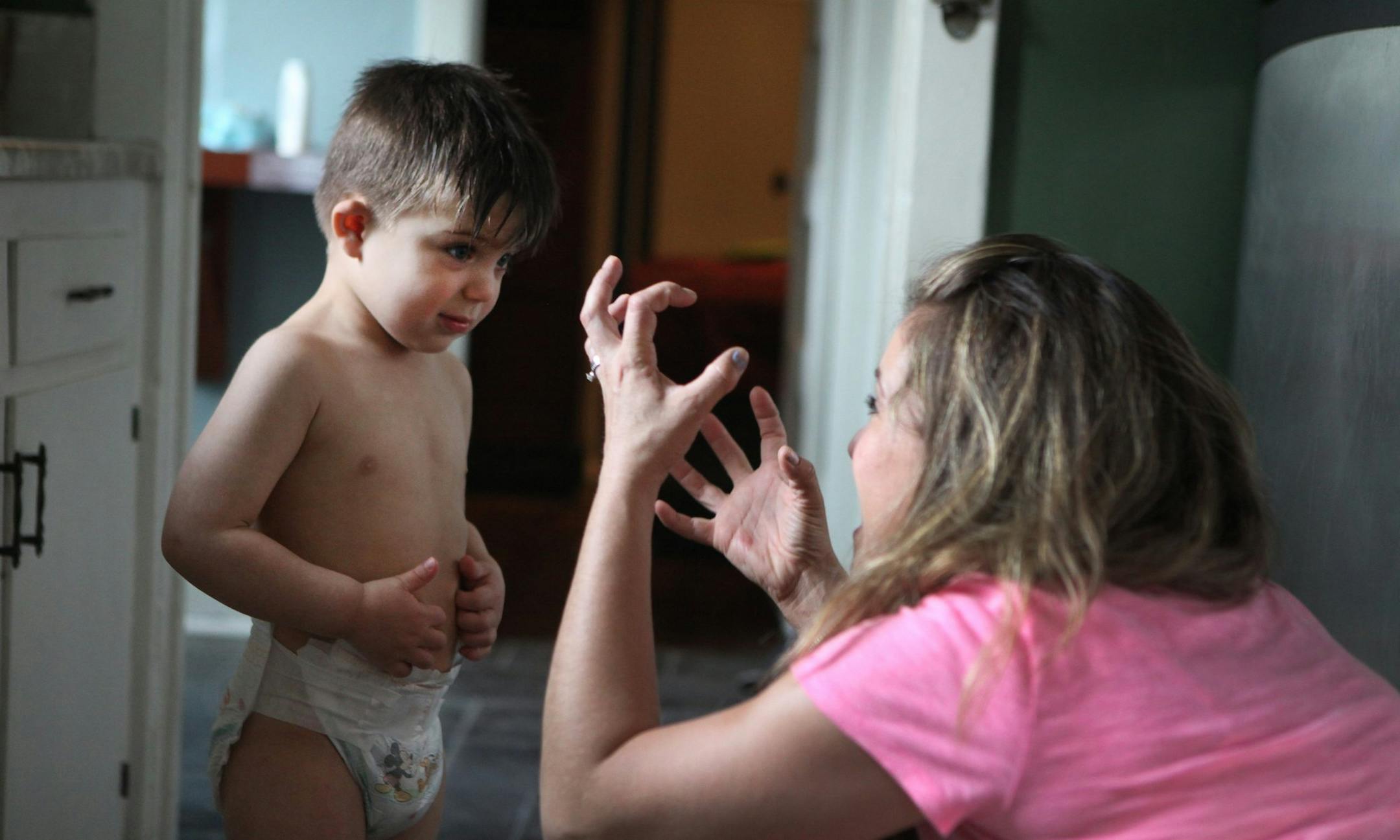 Deaf three-year-old Auguste Majkowski communicates with his mother Sophie Gareau using French Canadian sign language at their rented home in Los Angeles on May 3, 2014. The family, from Montreal, is in Los Angeles for a surgical procedure that involves inserting a device in Auguste's brain stem in the hope that it will help him hear. (Brian van der Brug/Los Angeles Times/MCT)