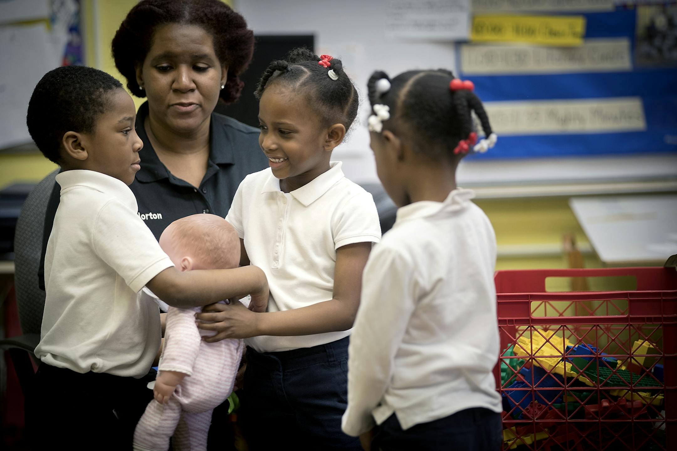 Pre-kindergarten teacher Priscilla Horton leads a group of students in role playing on the topic of sharing at Marcus Garvey Elementary School, Tuesday, March 21, 2017 in Chicago, IL.