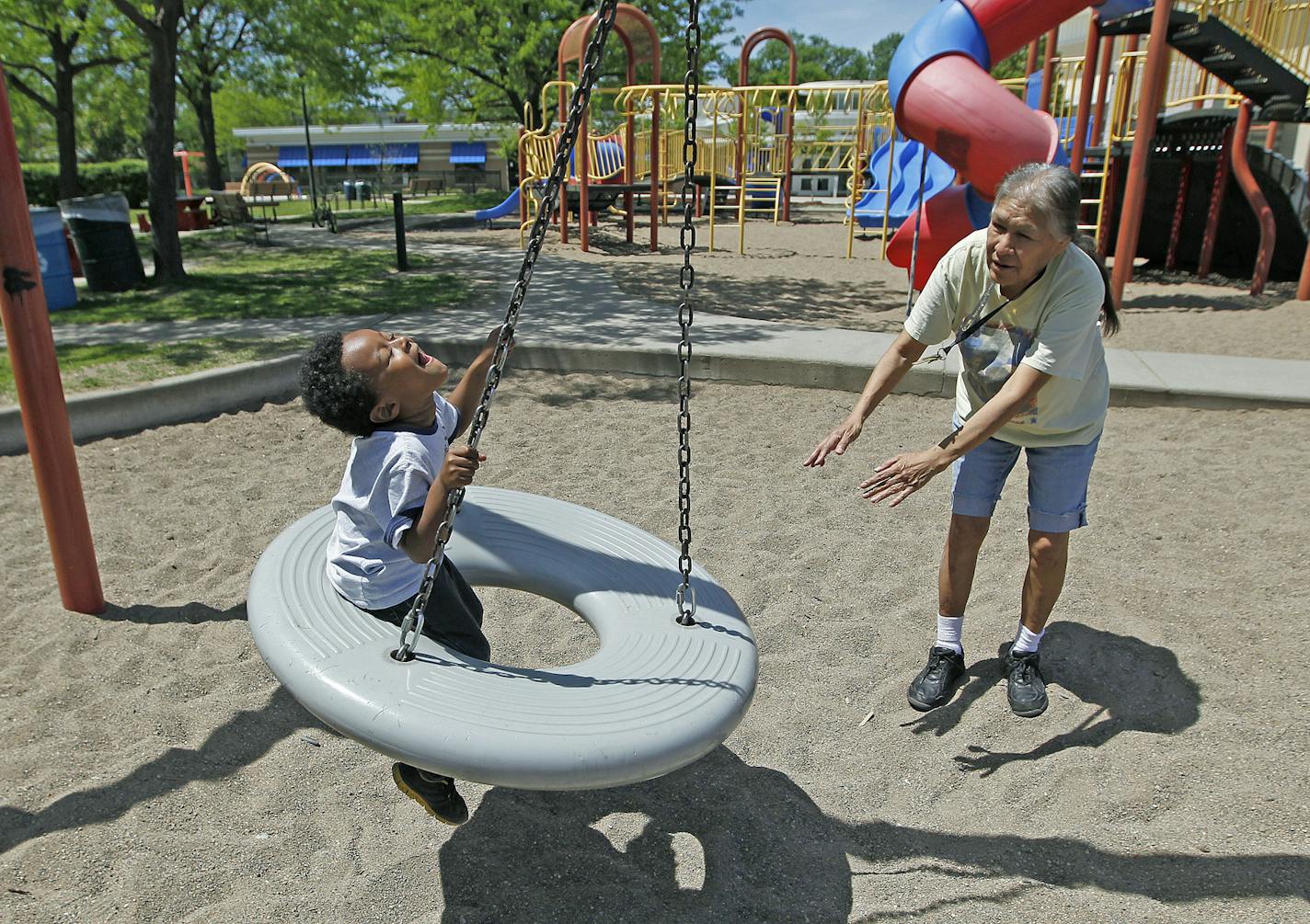 Carol House pushed her grandson Isaiah Halsall on a swing at the newly remodeled East Phillips Park May 29, 2014