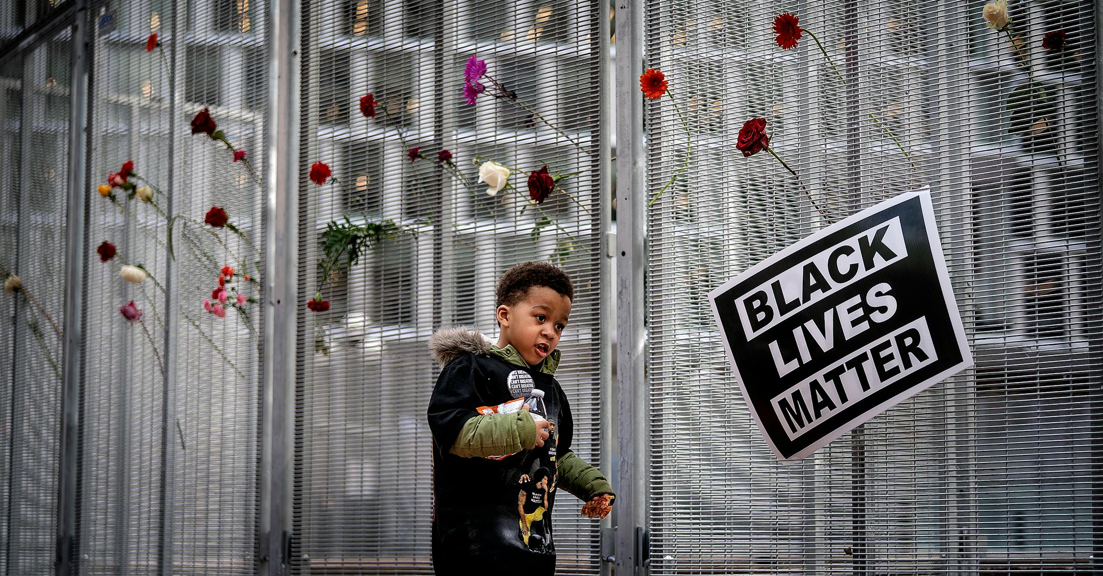 Rashaud Leake ,5, ran pass the barricaded fence at the Hennepin County Government Center during a rally mourning the death of George Floyd.