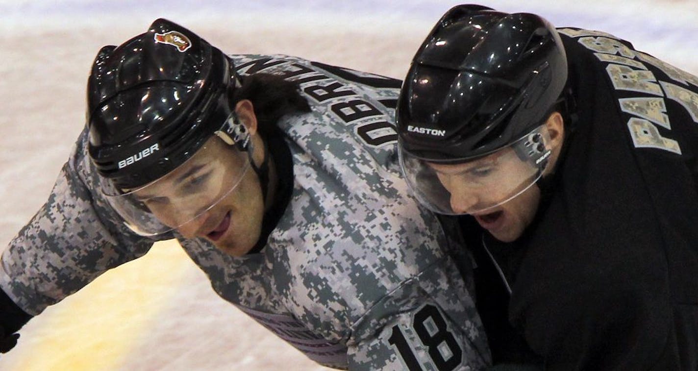 Exhibition game with locked-out NHL hockey players. Jimmy O'Brien, left, and Zach Parise got physical fighting for control of the puck. (MARLIN LEVISON/STARTRIBUNE(mlevison@startribune.com