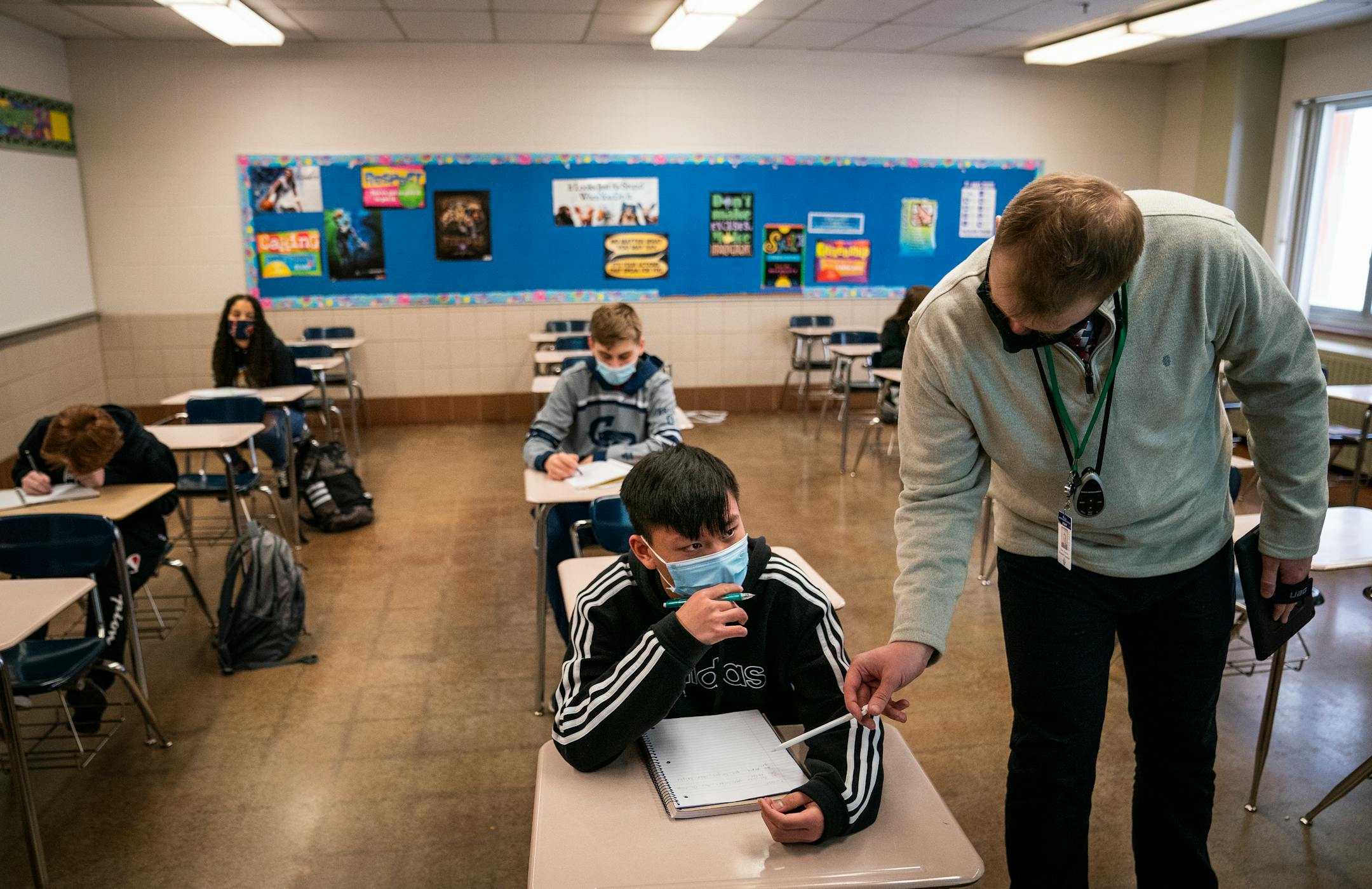 Eighth grader Chi Hai Nguyen gets help from student teacher Sam Carver in middle school algebra class at Jackson Middle School in Champlin.