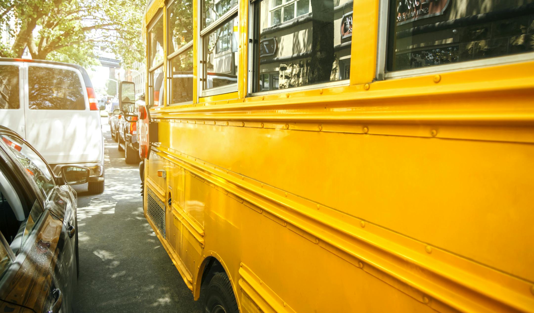Closeup of classic yellow school bus parked on the street. istock