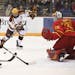 Minnesota Golden Gophers forward Tyler Sheehy (22) tried to feed an assist to forward Brannon McManus (7) against Ferris State Bulldogs goaltender Ron