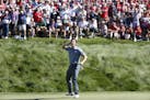 USA golfer, Rory McIlroy taunts the gallery to make some noise after sinking a long birdie putt on the 8th hole during match play against USA player, 