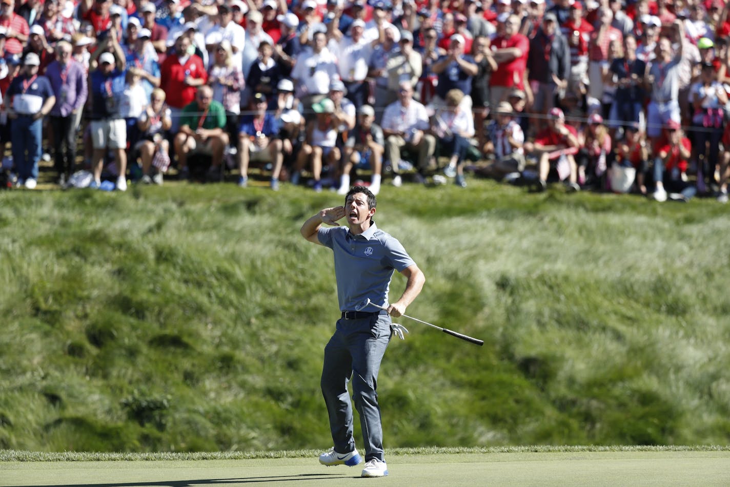 USA golfer, Rory McIlroy taunts the gallery to make some noise after sinking a long birdie putt on the 8th hole during match play against USA player, Patrick Reed, Sunday.