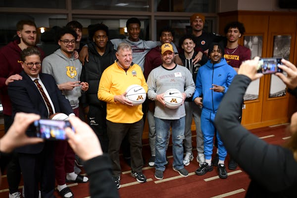 Gophers basketball players pose for photos with fans at a recent Dinkytown Athletes event at Williams Arena.