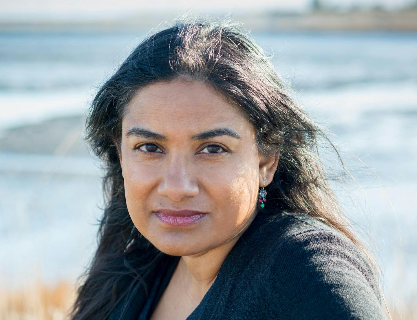 Author Anita Felicelli is photographed near a shoreline