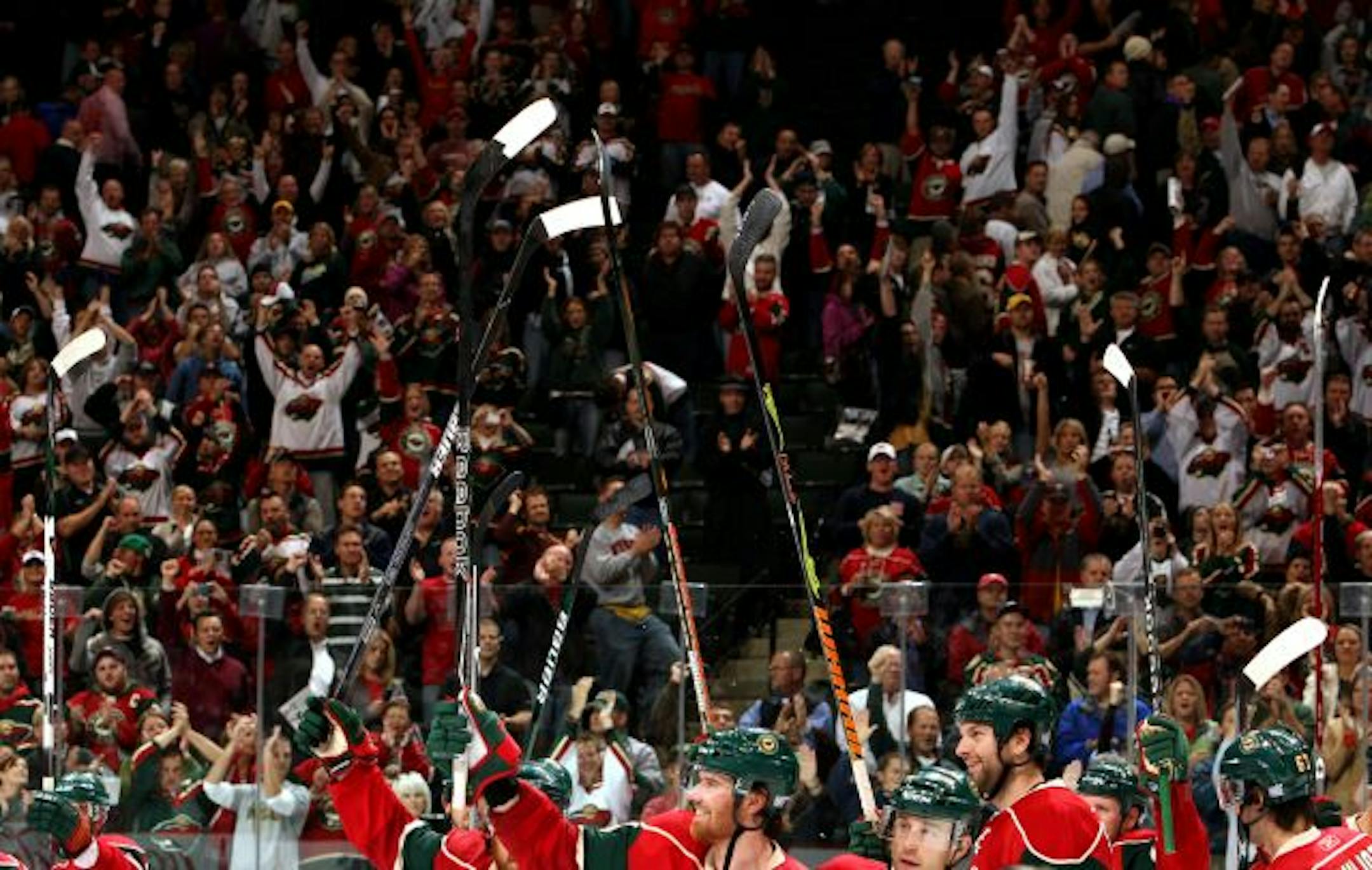 Minnesota Wild fans cheered for the team at the end of the game. Andrew Brunette (15) scored the winning goal in overtime. Minnesota beat Anaheim by a final score of 4-3.