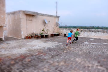 The rooftop of an apartment building in Delhi provided a place to run for travel-sore kids, and a view over the treetops of the Mehrauli area, once a 