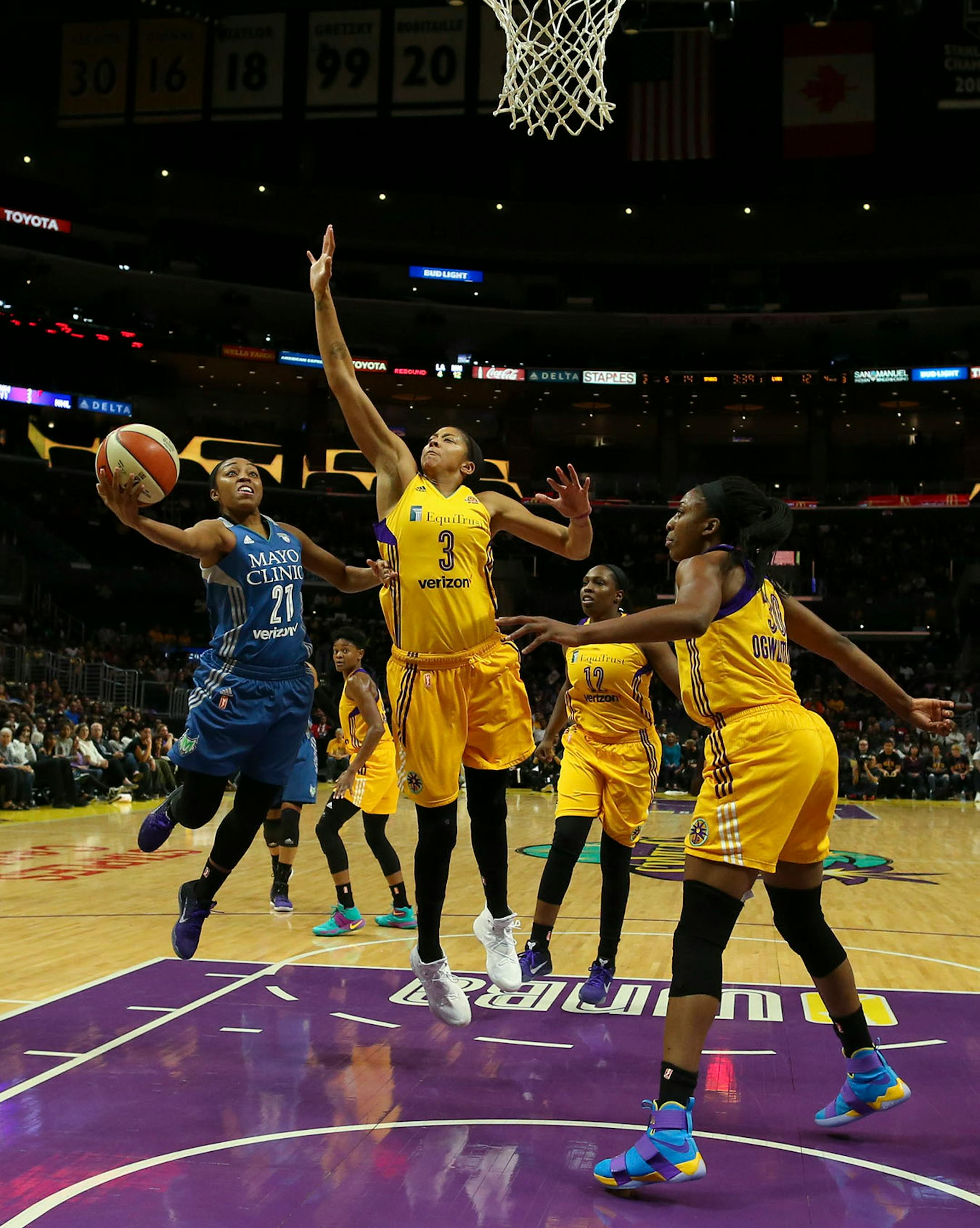 Minnesota Lynx guard Renee Montgomery (21) shot in the first quarter under the defense of Los Angeles Sparks forward Candace Parker (3).