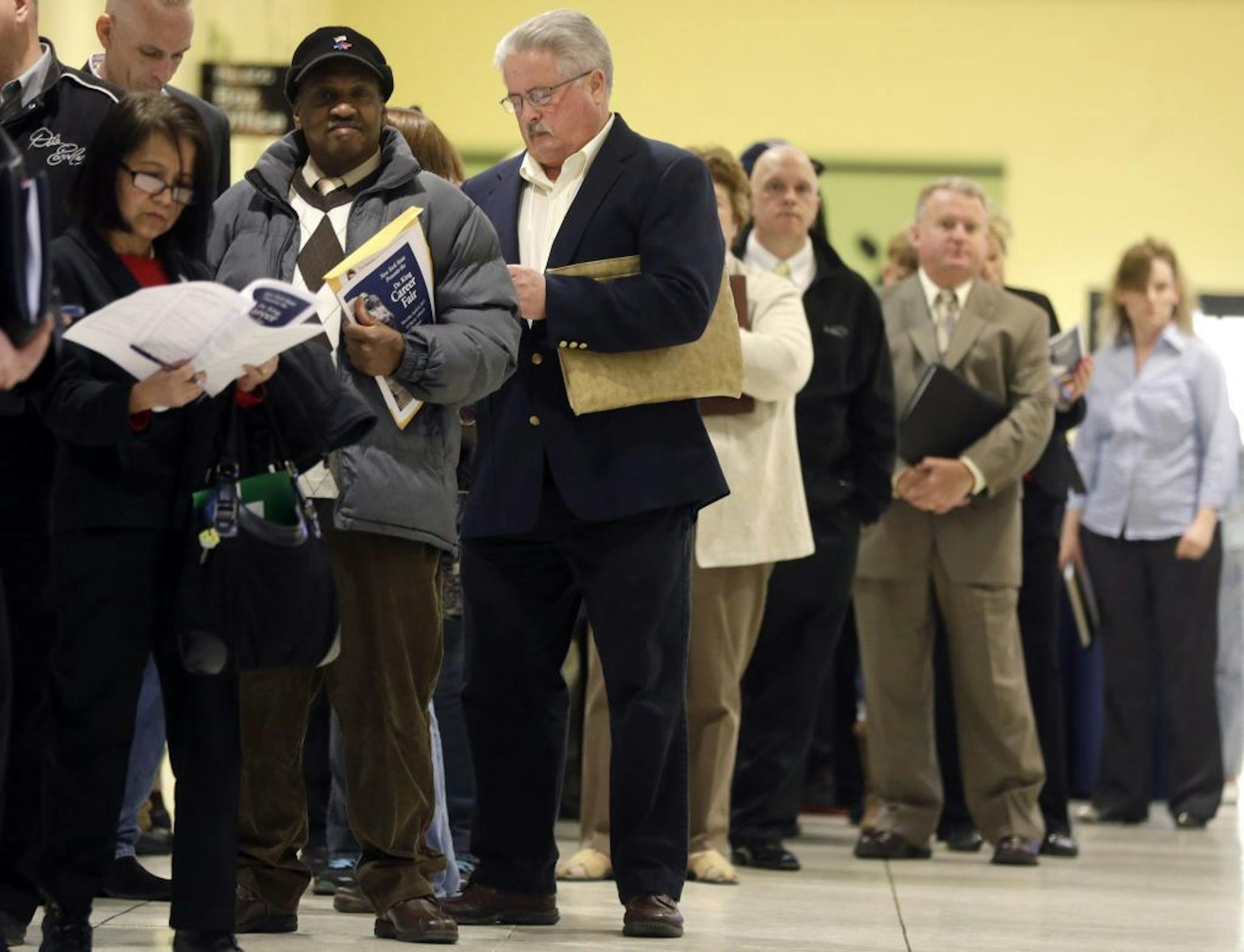 In this Thursday, April 11, 2013 photo, people wait in line before the Dr. King Career Fair at the Empire State Plaza Convention Center in Albany, N.Y. U.S. employers added 165,000 jobs in April, and hiring was much stronger in the previous two months than first thought, the Labor Department reports, Friday, May 3, 2013. The gains trimmed the unemployment rate to a four-year low of 7.5 percent.