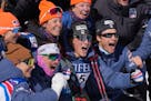 Gus Schumacher, center, celebrates with his teammates after winning the men's 10-kilometer World Cup race at Theodore Wirth Park.