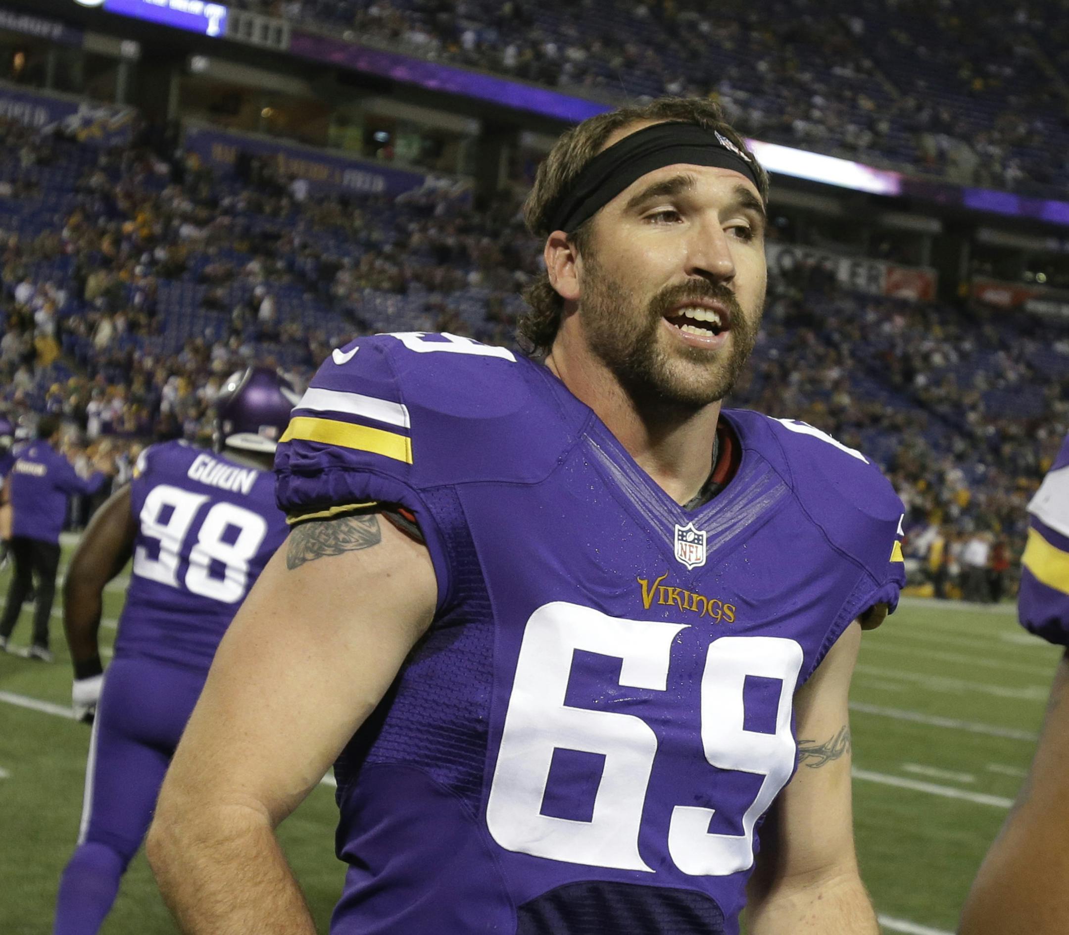 Minnesota Vikings defensive end Jared Allen (69) talk to defensive tackle Kevin Williams (93) before an NFL football game against the Green Bay Packers, Sunday, Oct. 27, 2013, in Minneapolis. (AP Photo/Jim Mone)