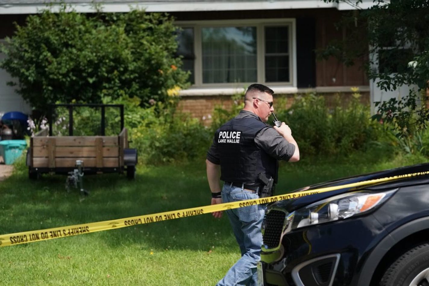 Police work outside a home Monday, July 29, 2019, in Lake Hallie, Wis., following a shooting the night before. Authorities in northwestern Wisconsin say shootings at two homes have left five people dead, including the suspected shooter, and two others injured.