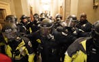 Riot police cleared the hallway inside the Capitol on Jan. 6, 2021, in Washington, D.C.