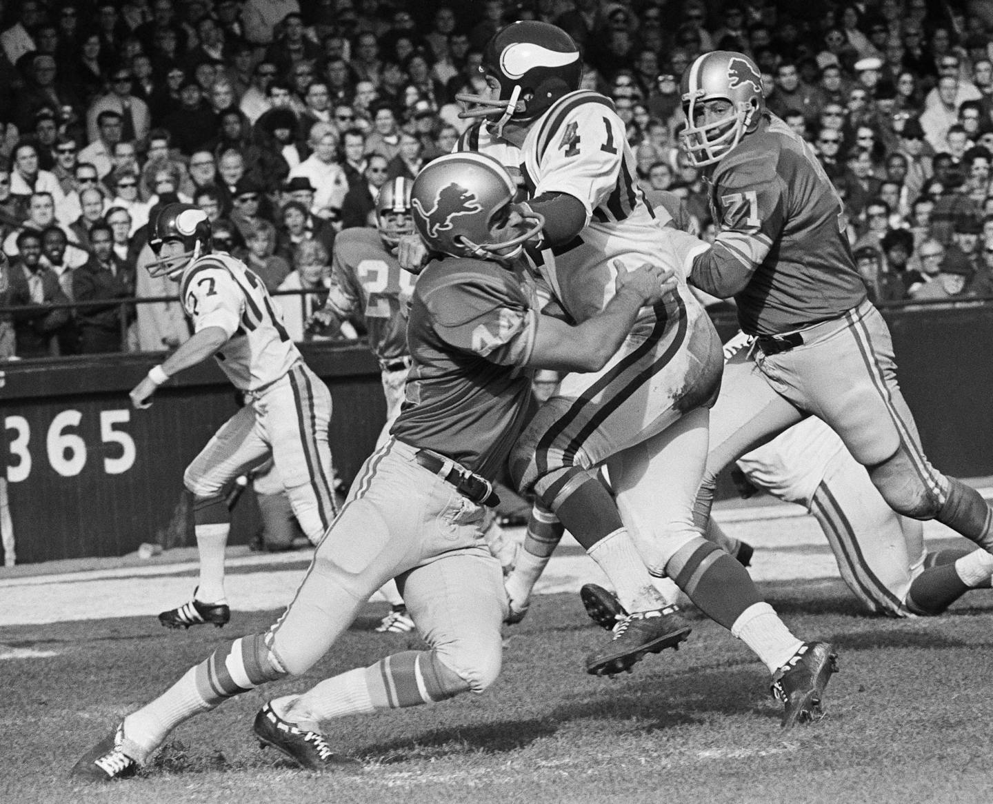 FILE - This Nov. 1, 1970 file photo shows Minnesota Viking's Dave Osborn (41) being tackled by Detroit Lions' Dick LeBeau (44), during a football game in Detroit. Also shown are Lions' Alex Karras (71) . As the decades passed and LeBeau was repeatedly left out of the Pro Football Hall of Fame, one of the pre-eminent defensive players of his era began to believe he wouldn't join the three other members of the Lions secondary who were already enshrined. (AP Photo/Richard Sheinwald, File) ORG XMIT: