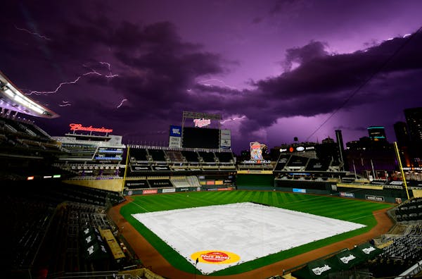 Lightning crackled over Target Field after Friday night's game between the Twins and the Royals was postponed due to weather.