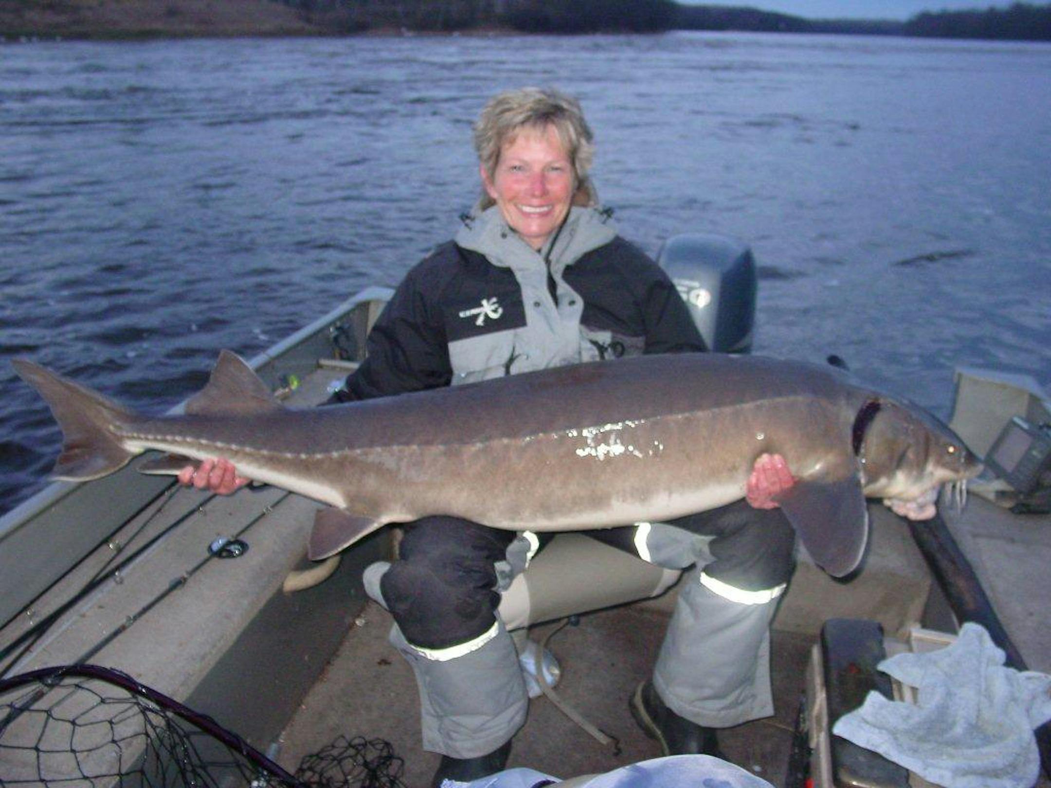 Julie Peterson with a 68 1/4 inch sturgeon caught on Rainy River.