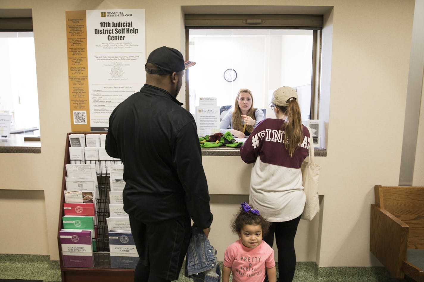 Rashaad Wren, left, his wife Alicia, right, with their daughter Bailee, 1, seek help on custody questions concerning Alicia's other children with attorney Molly Buckrey at the Legal Self-Help Center. ] LEILA NAVIDI &#xef; leila.navidi@startribune.com BACKGROUND INFORMATION: The Legal Self-Help Center located at the Anoka County Courthouse in Anoka on Tuesday, March 28, 2017. A look at a new but growing legal self-help center program in the tenth judicial district. While other counties run simila