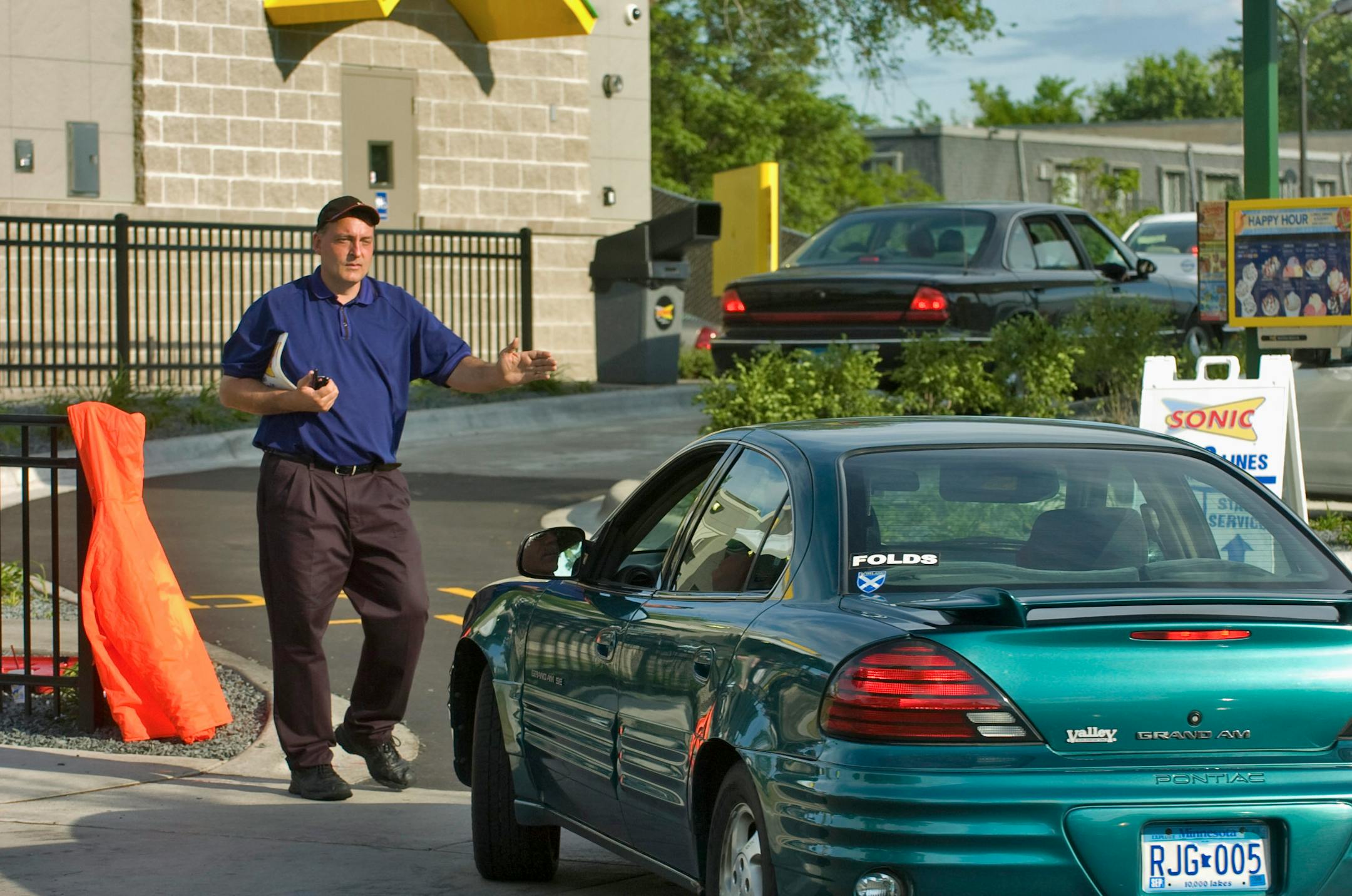 Directing the flow of traffic into the newly opened Sonic is employee Todd Dolan.
