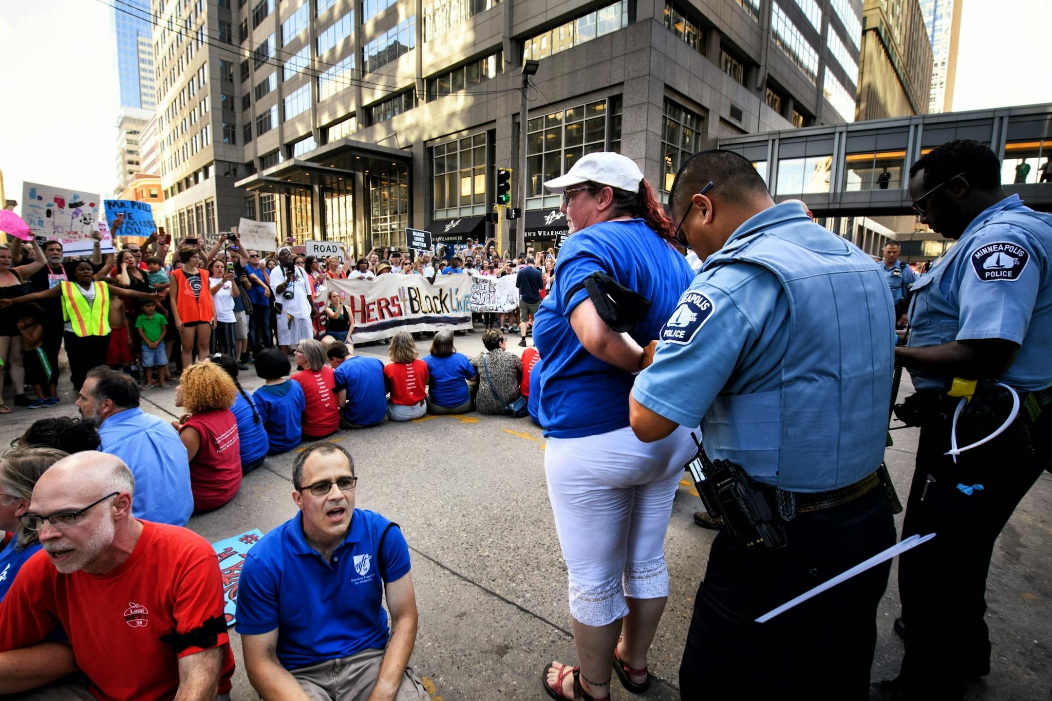 The protesters stopped in front of US Bancorp Center to protest the bank's policies. Twenty one were arrested including MFT organizer Lynne Bolton of the Minneapolis Federation of Teachers here.