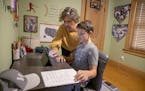 Paul Hendricks, 10, received some guidance from his mother Anne, as he worked his first day of 5th-grade from his bedroom, Tuesday, September 8, 2020 