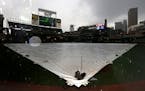 A tarp covered the infield at Target Field as the rain fell before Monday night's game. ] CARLOS GONZALEZ cgonzalez@startribune.com - May 9, 2016, Min