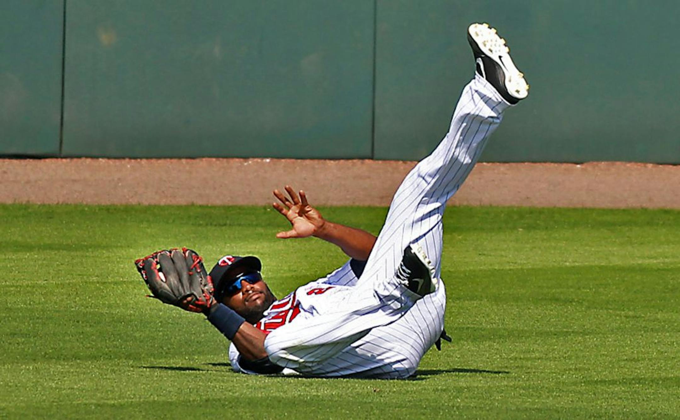 Minnesota Twins Denard Span held on to the ball after making a grab in the centerfield for an out in the fourth inning Thursday, March 3, 2012 at Hammond Stadium in Ft. Myers, Fla.