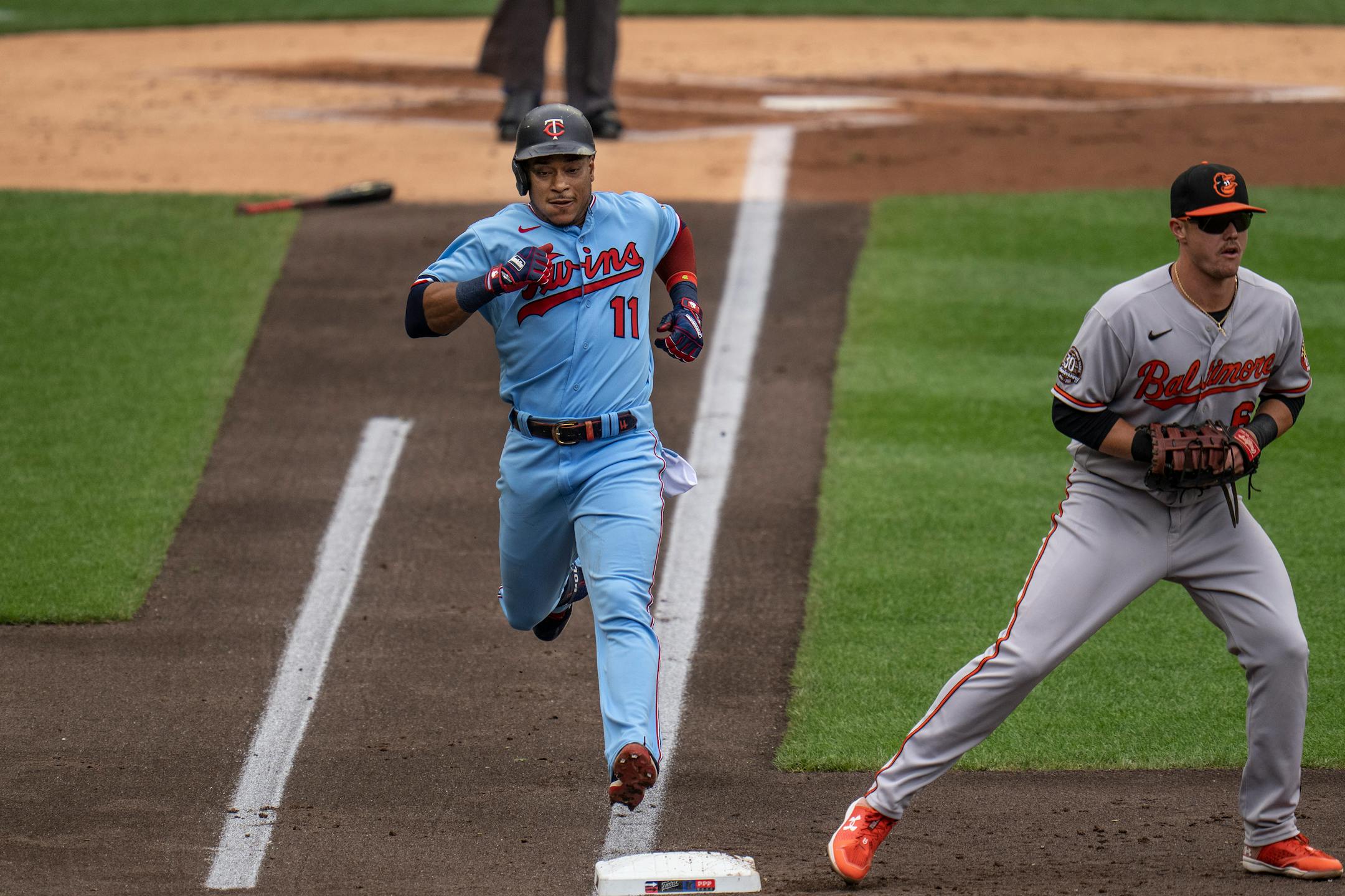 Minnesota Twins second baseman Jorge Polanco (11) singles in the first inning as Baltimore Orioles first baseman Ryan Mountcastle (6) waited for the ball.