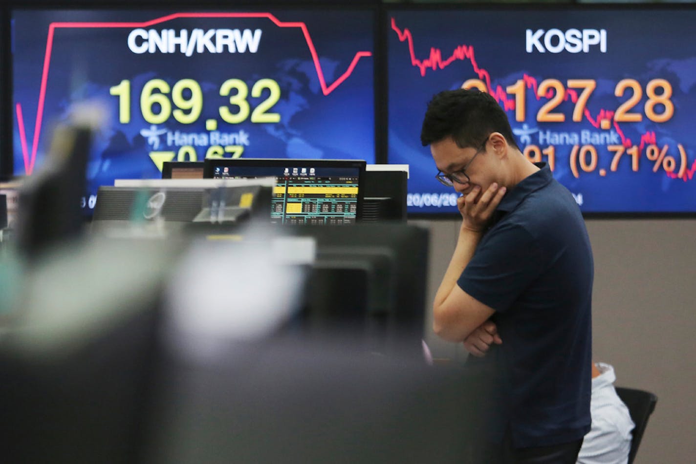 A currency trader works at the foreign exchange dealing room of the KEB Hana Bank headquarters in Seoul, South Korea, Friday, June 26, 2020.