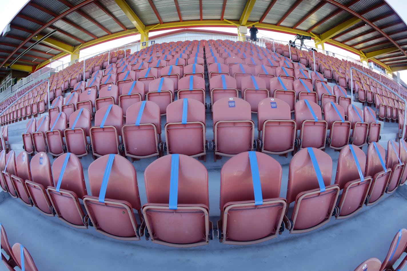 In this image taken with a fisheye lens, seating is taped off to meet social distancing needs before the start of the NWSL Challenge Cup soccer match between the Portland Thorns FC and the North Carolina Courage at Zions Bank Stadium Saturday, June 27, 2020, in Herriman, Utah. (AP Photo/Rick Bowmer)