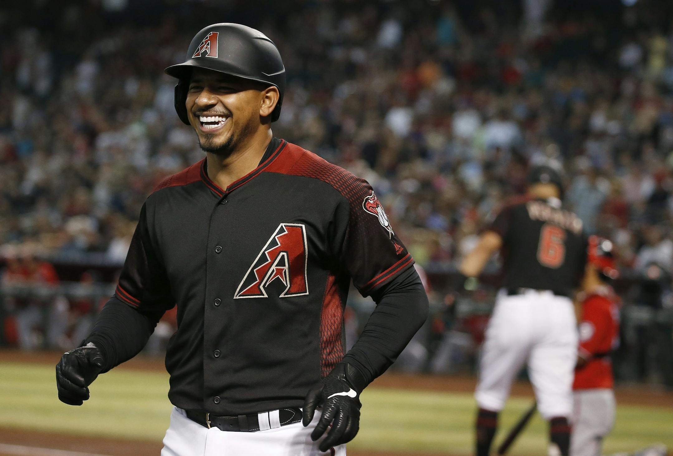 Arizona Diamondbacks' Eduardo Escobar smiles as he arrives back at the dugout after hitting a two-run home run against the Washington Nationals during the first inning of a baseball game Saturday, Aug. 3, 2019, in Phoenix. (AP Photo/Ross D. Franklin)
