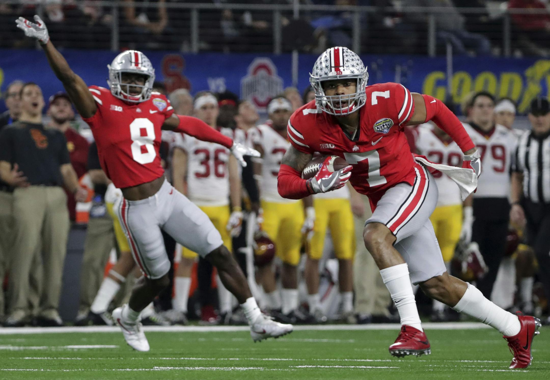 Ohio State safety Damon Webb (7) runs an interception in for a touchdown in front of cornerback Kendall Sheffield (8) during the first half of the Cotton Bowl NCAA college football game against Southern California in Arlington, Texas, Friday, Dec. 29, 2017. (AP Photo/LM Otero)
