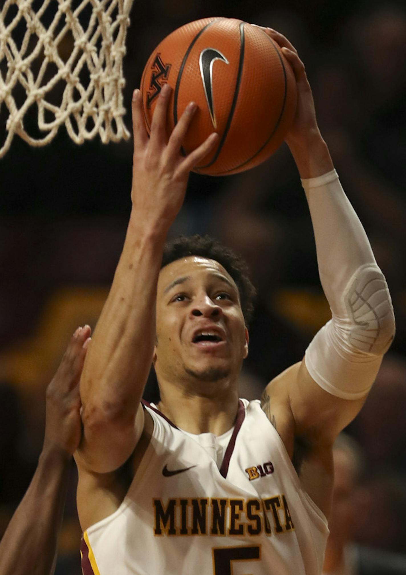 Minnesota Gophers guard Amir Coffey (5) made a first half shot over Northwestern guard Anthony Gaines (11). ] JEFF WHEELER &#xef; jeff.wheeler@startribune.com The beleaguered University of Minnesota men's basketball team faced the Northwestern Wildcats in a Big 10 conference game Tuesday night, January23, 2018 at Williams Arena in Minneapolis. ORG XMIT: MIN1801232106490381