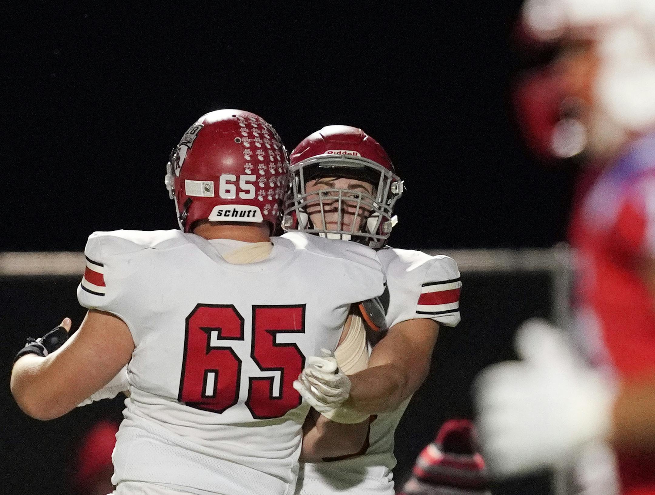 Elk River offensive lineman Seth Hopkins (65) congratulated running back Myles Gordon (25) after he got a two point conversion following a touchdown in the fist half. ] ANTHONY SOUFFLE • anthony.souffle@startribune.com Robbinsdale Armstrong High School played Elk River in a Class 5A, Section 6 football championship game Friday, Nov. 1, 2019 at St. Michael-Albertville High School in St. Michael, Minn.