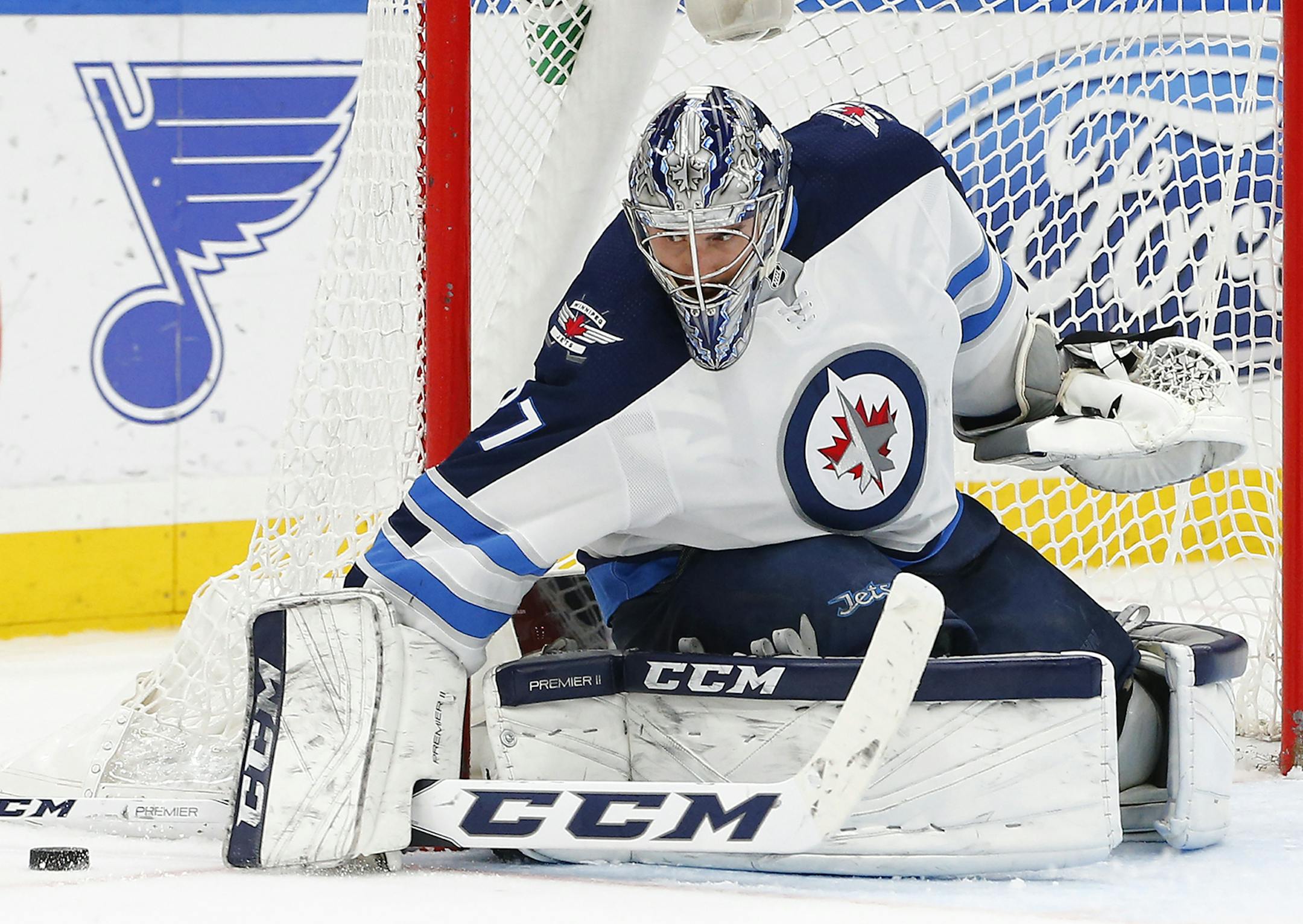 Winnipeg Jets goaltender Connor Hellebuyck stops a shot during the second period of an NHL hockey game against the St. Louis Blues, Friday, Feb. 23, 2018, in St. Louis. (AP Photo/Billy Hurst) ORG XMIT: MOBH111