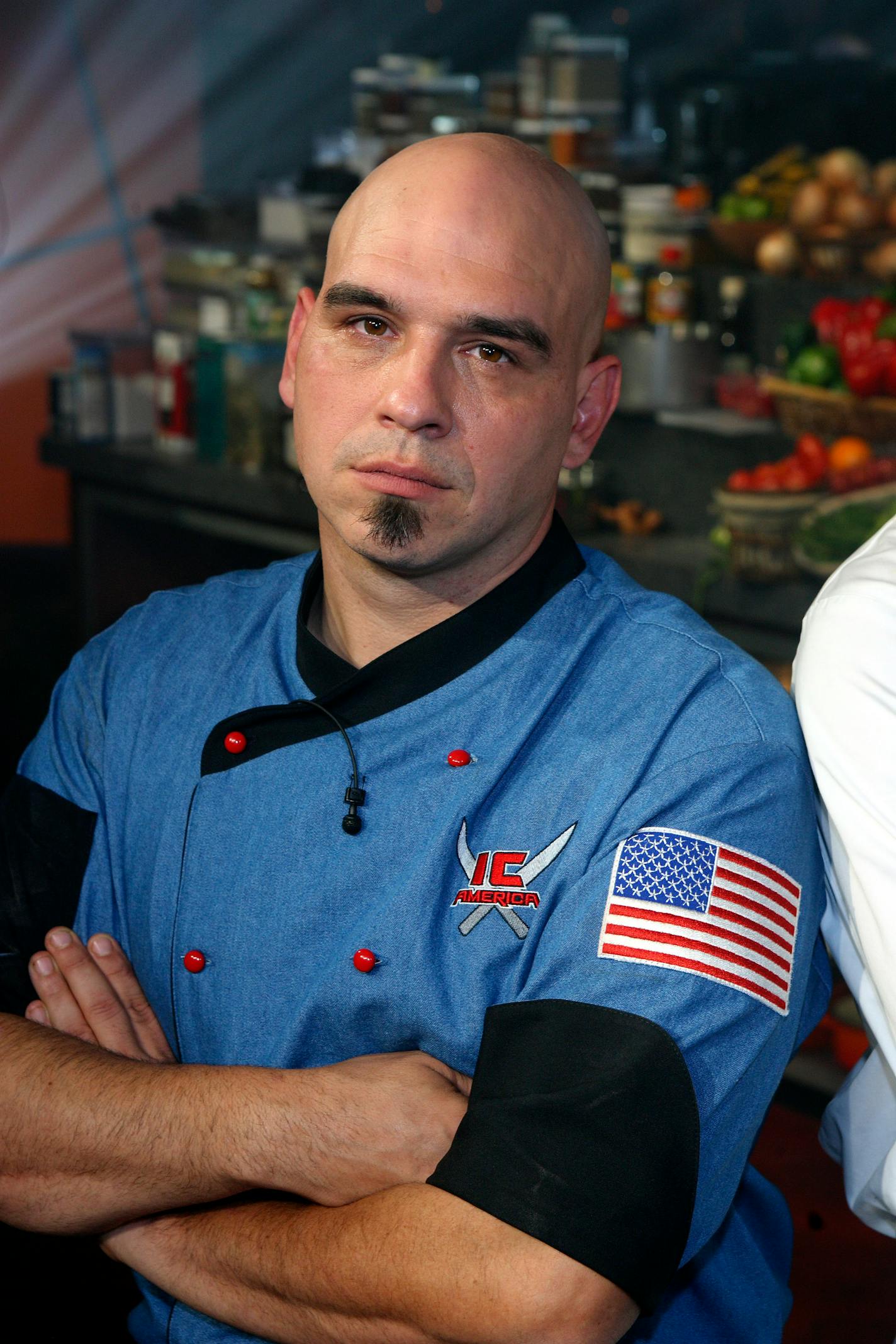 In this image released by Food Network, chef, Michael Symon, is shown. The network on Monday, April 21, 2008, announced that Ohio chef Michael Symon will take over as host of the "Dinner: Impossible" series, which challenges its chef to prepare meals under extreme conditions. Symon, who won the network's The Next Iron Chef competition in 2007 and appears on its Iron Chef America series, replaces Robert Irvine, who left last month following revelations that he'd exaggerated details of resume.