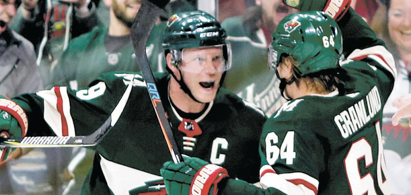 Wild center Mikko Koivu, left, celebrated with right winger Mikael Granlund after Granlund's first-period goal in Minnesota's 5-2 victory over Dallas at Xcel Energy Center on Thursday night.